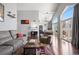 Sunlit living room with hardwood floors and access to balcony at 3335 S Monaco Pkwy # D, Denver, CO 80222
