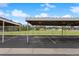 Covered parking spaces with view of grassy field at 3335 S Monaco Pkwy # D, Denver, CO 80222