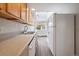 Modern kitchen featuring light wood cabinets, updated countertops, and a white refrigerator at 5055 E Dartmouth Ave, Denver, CO 80222