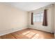 Bright bedroom with hardwood floors, a large window, and natural light at 1024 E 14Th Ave # 10, Denver, CO 80218