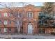 Charming brick building with a decorative facade, lush trees, and a neatly maintained front entrance at 1024 E 14Th Ave # 10, Denver, CO 80218