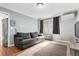 Living room with hardwood floors, a large window, and a comfortable gray couch at 1024 E 14Th Ave # 10, Denver, CO 80218