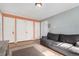 Cozy living room featuring a gray sofa, wood floors, and convenient closet space at 1024 E 14Th Ave # 10, Denver, CO 80218