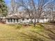 Large backyard featuring mature trees and a fire pit for outdoor enjoyment at 10050 W 8Th Pl, Lakewood, CO 80215