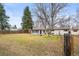 Spacious backyard with patio, mature trees, and a fire pit at 10050 W 8Th Pl, Lakewood, CO 80215