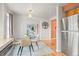 Modern dining area with view to entry featuring stainless refrigerator and hardwood flooring at 10050 W 8Th Pl, Lakewood, CO 80215