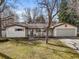 Charming single-story home with a well-manicured front yard and a two-car garage, showcasing classic curb appeal at 10050 W 8Th Pl, Lakewood, CO 80215