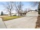 Charming single-story home with a spacious driveway and well-maintained lawn, perfect for Gathering living at 10050 W 8Th Pl, Lakewood, CO 80215