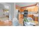 Well-lit kitchen features stainless appliances, warm wood cabinets, and adjacent dining area at 10050 W 8Th Pl, Lakewood, CO 80215