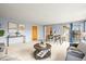 Bright living room featuring neutral color scheme, modern decor, and sliding glass doors to backyard at 10050 W 8Th Pl, Lakewood, CO 80215