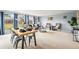 Bright, open living space with large windows, comfortable seating, and dining area at 10050 W 8Th Pl, Lakewood, CO 80215