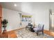 Inviting living room with hardwood floors, a cozy rug, and stylish seating, creating a comfortable and airy space at 10050 W 8Th Pl, Lakewood, CO 80215