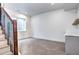 Finished basement area with plush carpet, a staircase with metal railing, and a countertop at 4401 S Clarkson St, Englewood, CO 80113