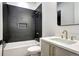 Updated bathroom featuring a modern vanity, quartz countertop, tile shower, and brass fixtures at 4401 S Clarkson St, Englewood, CO 80113