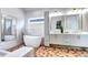 Elegant bathroom features a freestanding tub, double vanity, and modern lighting at 4401 S Clarkson St, Englewood, CO 80113