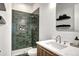 Modern bathroom features a sleek vanity, tiled shower with built-in niche, and stylish fixtures at 4401 S Clarkson St, Englewood, CO 80113