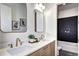 Bright bathroom featuring double sinks, quartz countertops, modern lighting, and a tiled shower/tub combo at 4401 S Clarkson St, Englewood, CO 80113