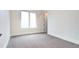 Minimalist bedroom with carpet flooring, white walls, and a large window at 4401 S Clarkson St, Englewood, CO 80113