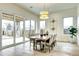 Elegant dining room with a large sliding glass door, wood floors, and seating for six at 4401 S Clarkson St, Englewood, CO 80113