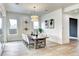 Bright dining room with large windows, a stylish light fixture, and seating for six at 4401 S Clarkson St, Englewood, CO 80113