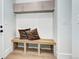 Entryway featuring a built-in bench with decorative pillows and overhead storage at 4401 S Clarkson St, Englewood, CO 80113