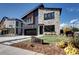 Stunning modern home exterior featuring stone accents, sleek black siding, and a well-manicured front lawn at 4401 S Clarkson St, Englewood, CO 80113