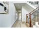 Bright hallway with modern wood flooring, leading to an open staircase and various rooms within the home at 4401 S Clarkson St, Englewood, CO 80113