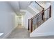 Hallway with plush carpet, a staircase with metal railing, and a view of a door at the end at 4401 S Clarkson St, Englewood, CO 80113