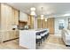 Modern kitchen featuring a waterfall island with bar seating and designer light fixtures at 4401 S Clarkson St, Englewood, CO 80113