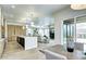 Modern kitchen featuring a large island with quartz countertops, custom cabinetry, and an open floor plan to the living room at 4401 S Clarkson St, Englewood, CO 80113