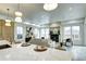 Open-concept kitchen with quartz countertops, a modern island, and a seamless flow into the living room and fireplace at 4401 S Clarkson St, Englewood, CO 80113