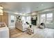 Bright and airy living room featuring a modern fireplace, comfortable seating, and large windows offering natural light at 4401 S Clarkson St, Englewood, CO 80113