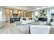 Elegant living room with wood floors, neutral tones, and a seamless transition to the adjacent gourmet kitchen at 4401 S Clarkson St, Englewood, CO 80113