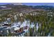 Stunning aerial view of a luxury home nestled among snow-covered trees and mountains at 327 Peerless Dr, Breckenridge, CO 80424