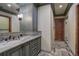 Elegant bathroom featuring custom cabinetry, granite countertops, and decorative tile accents at 327 Peerless Dr, Breckenridge, CO 80424