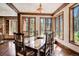Inviting dining area with wood floors, large windows, and a rustic table with seating for eight at 327 Peerless Dr, Breckenridge, CO 80424