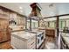 Beautiful open-concept kitchen featuring stainless steel appliances, a granite island, and wood beam architecture at 327 Peerless Dr, Breckenridge, CO 80424