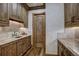 Kitchenette area featuring wood cabinets, stone counters, tiled backsplash, and under cabinet lighting at 327 Peerless Dr, Breckenridge, CO 80424