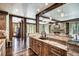 Spacious kitchen featuring a large island with granite countertops and wood beam architectural details at 327 Peerless Dr, Breckenridge, CO 80424