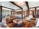 Open-concept living room with wooden beams, hardwood floors, and a partial view of the kitchen at 327 Peerless Dr, Breckenridge, CO 80424