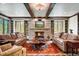 Comfortable living room showcasing a stone fireplace, wood beams, and built-in shelving on either side at 327 Peerless Dr, Breckenridge, CO 80424