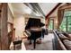 Grand piano in living room with exposed beam and comfortable couch seating at 327 Peerless Dr, Breckenridge, CO 80424