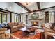 Spacious living room featuring a stone fireplace, wooden beams, built-in shelves, and an eclectic wood coffee table at 327 Peerless Dr, Breckenridge, CO 80424