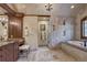 Main bathroom featuring stone floors and walls, dual vanities, walk-in shower and separate soaking tub at 327 Peerless Dr, Breckenridge, CO 80424