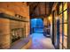 Outdoor patio with stone fireplace, wood beams, and a view of trees and mountain scenery at 327 Peerless Dr, Breckenridge, CO 80424