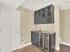Basement kitchenette with gray cabinets, granite countertop, a beverage fridge, and a stylish glass-door display at 8380 Blackgum St, Parker, CO 80134
