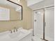 Bright bathroom featuring a white vanity with modern fixtures and a glass-enclosed shower, creating a clean aesthetic at 8380 Blackgum St, Parker, CO 80134