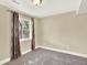 Carpeted bedroom with a ceiling light and a window with decorative curtains offering natural light at 8380 Blackgum St, Parker, CO 80134