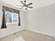 Bright bedroom featuring neutral carpet, ceiling fan, and a window with patterned valance, a cozy atmosphere at 8380 Blackgum St, Parker, CO 80134
