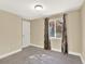 Carpeted bedroom featuring a ceiling light and a window with decorative curtains, offering ample natural light at 8380 Blackgum St, Parker, CO 80134
